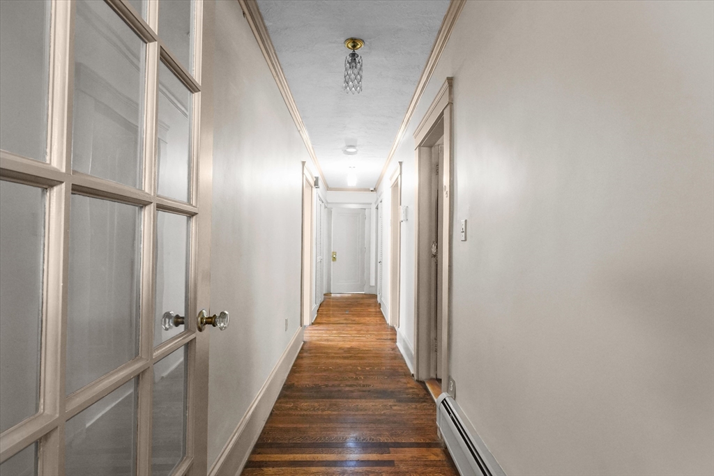 37-39 South Main Street Millbury, MA 01527 - Photo 11 of 42 a view of a hallway with wooden floor and staircase