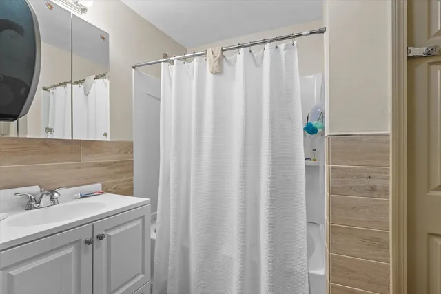 a bathroom with a sink a vanity and a shower