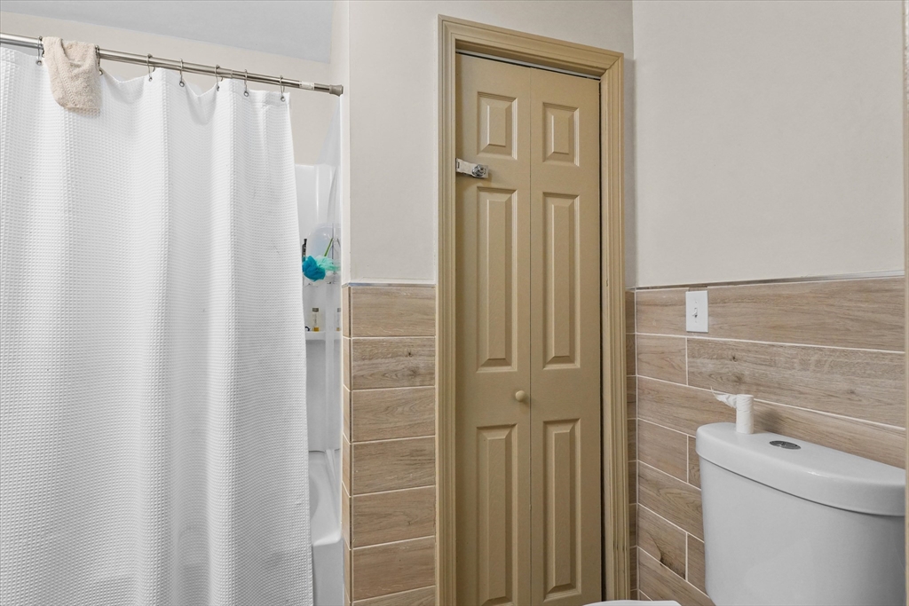 37-39 South Main Street Millbury, MA 01527 - Photo 15 of 42 a bathroom with a shower and a shower curtain