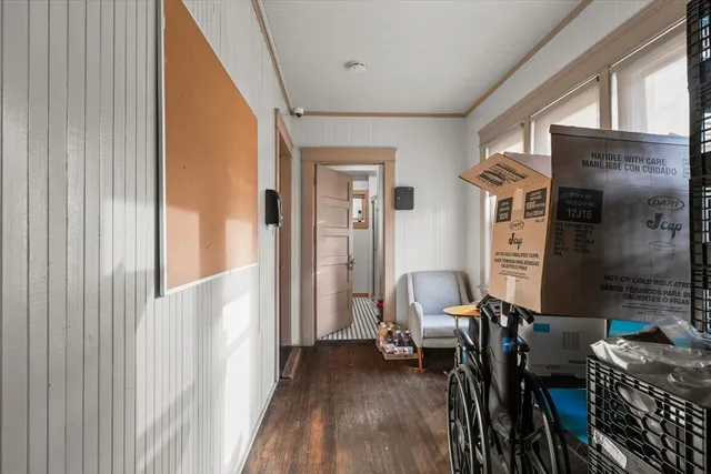 a view of a hallway with furniture and windows