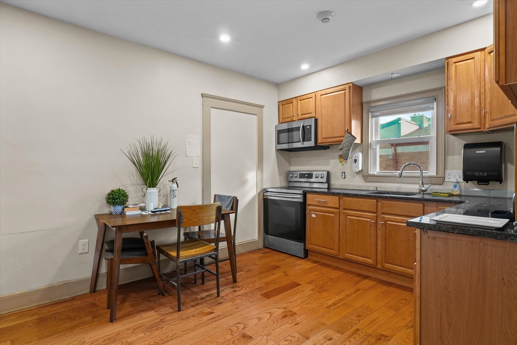 37-39 South Main Street Millbury, MA 01527 - Photo 21 of 42 a kitchen with stainless steel appliances granite countertop sink stove top oven and cabinets