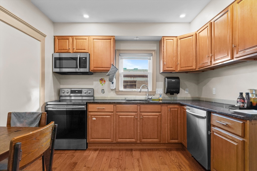 37-39 South Main Street Millbury, MA 01527 - Photo 22 of 42 a kitchen with stainless steel appliances granite countertop a sink stove cabinets and refrigerator