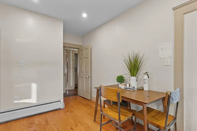 a dining room with furniture and front door
