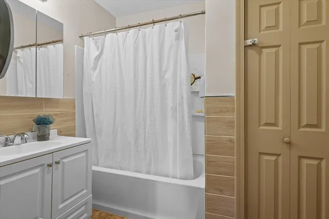 a bathroom with a shower curtain and a sink