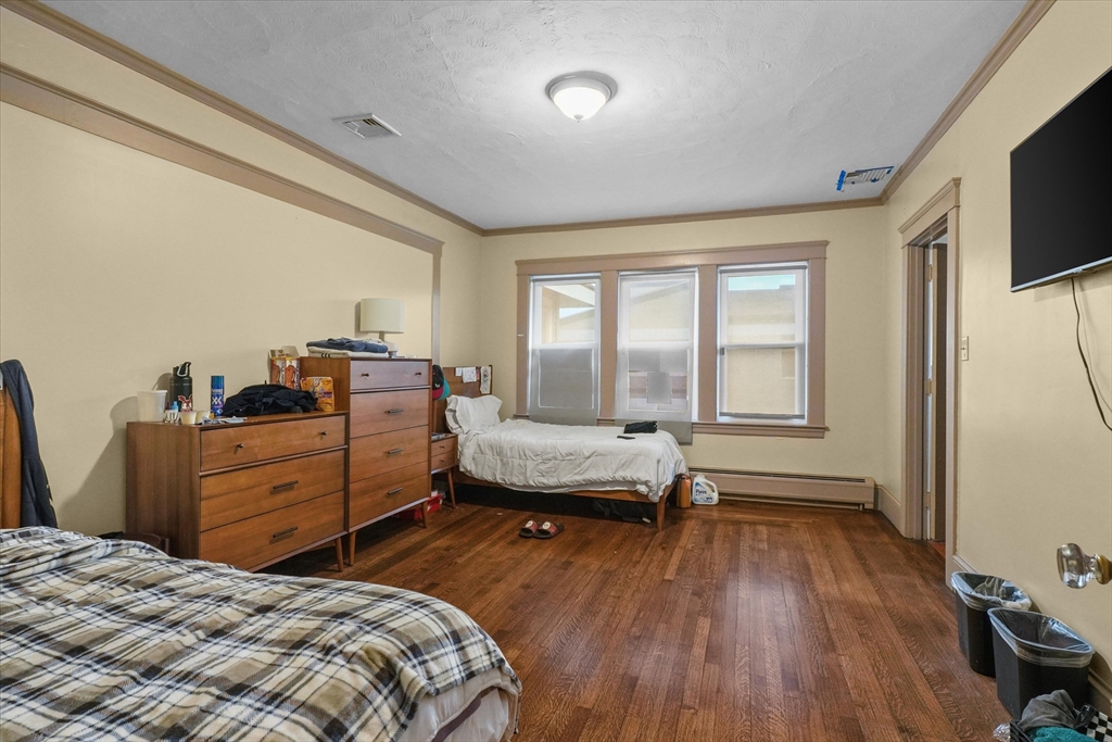 37-39 South Main Street Millbury, MA 01527 - Photo 31 of 42 a bedroom with a bed and wooden floor