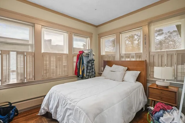 a bed sitting in a bedroom next to a window