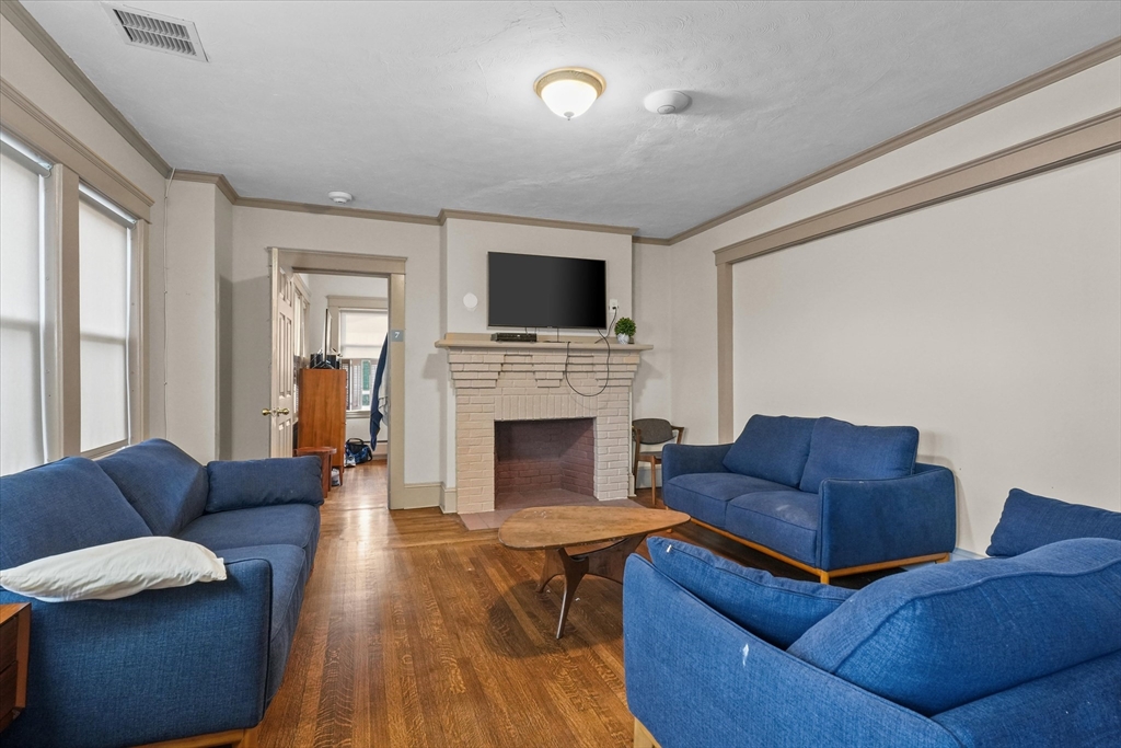 37-39 South Main Street Millbury, MA 01527 - Photo 36 of 42 a living room with furniture a flat screen tv and a fireplace