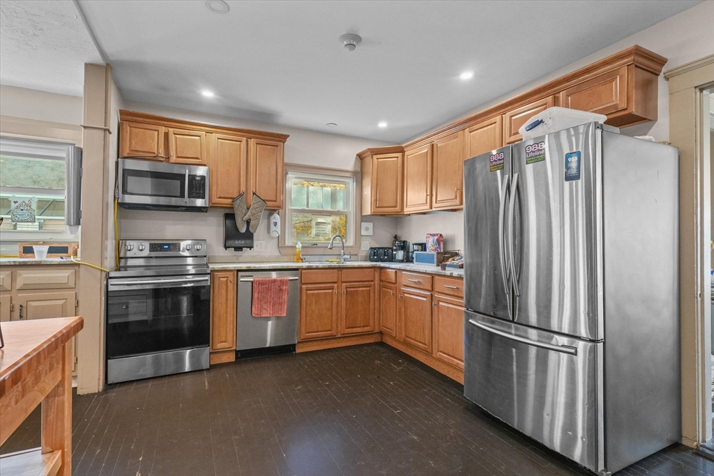 37-39 South Main Street Millbury, MA 01527 - Photo 4 of 42 a kitchen with stainless steel appliances granite countertop a refrigerator a stove a sink and a microwave