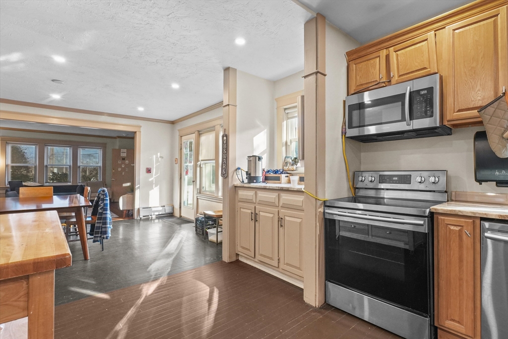 37-39 South Main Street Millbury, MA 01527 - Photo 5 of 42 a kitchen with stainless steel appliances granite countertop a stove a sink and a microwave