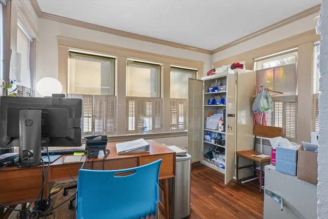 a room with furniture a bookshelf and a window