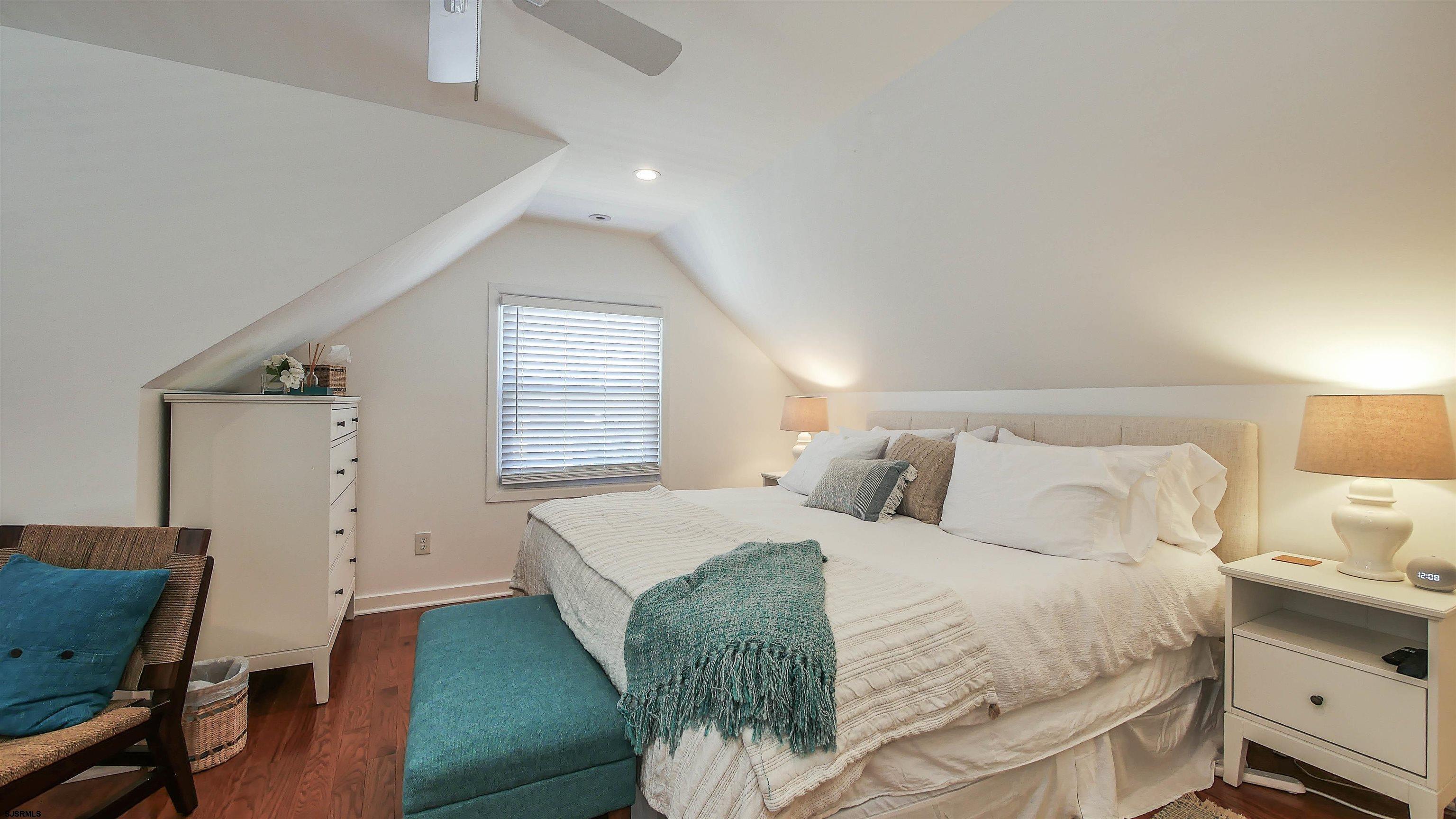 12 North Delavan Avenue, Unit AUGUST 1ST LABOR DAY 2026 Margate City, NJ 08402 - Photo 25 of 41 a bedroom with a bed and a chair