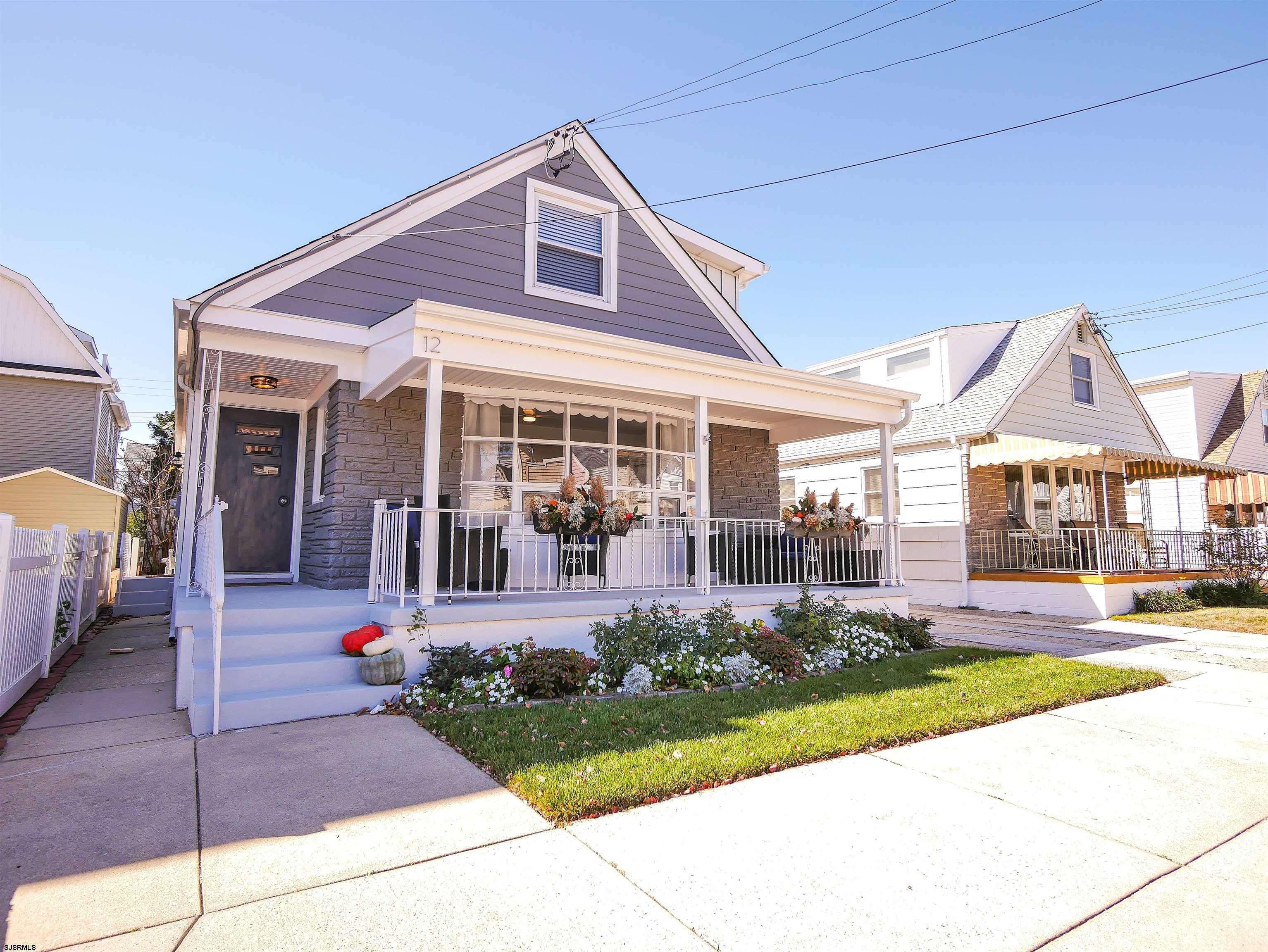 12 North Delavan Avenue, Unit AUGUST 1ST LABOR DAY 2026 Margate City, NJ 08402 - Photo 32 of 41 a front view of a house with a yard