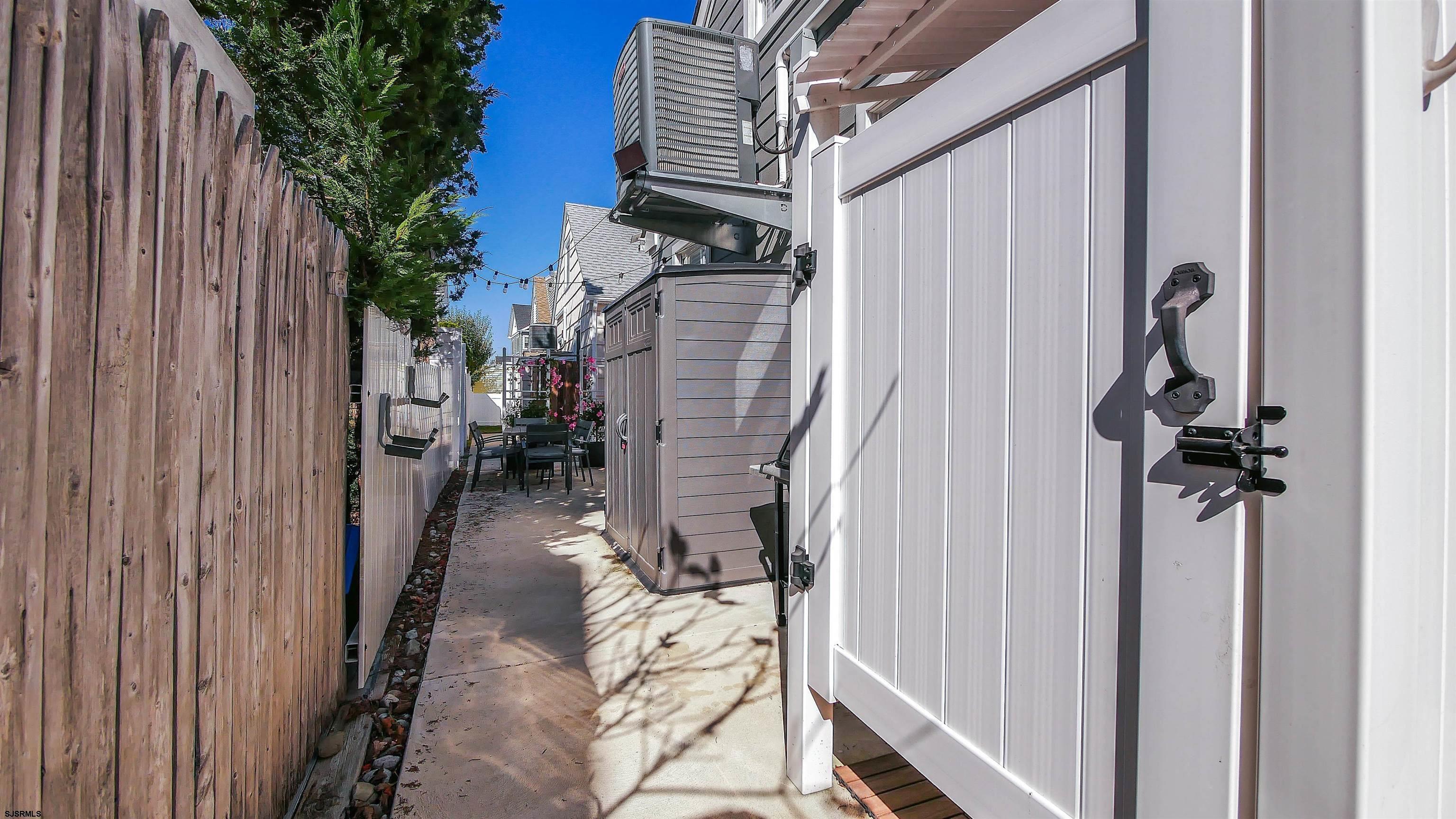 12 North Delavan Avenue, Unit AUGUST 1ST LABOR DAY 2026 Margate City, NJ 08402 - Photo 39 of 41 a view of a balcony with wooden floor and stairs