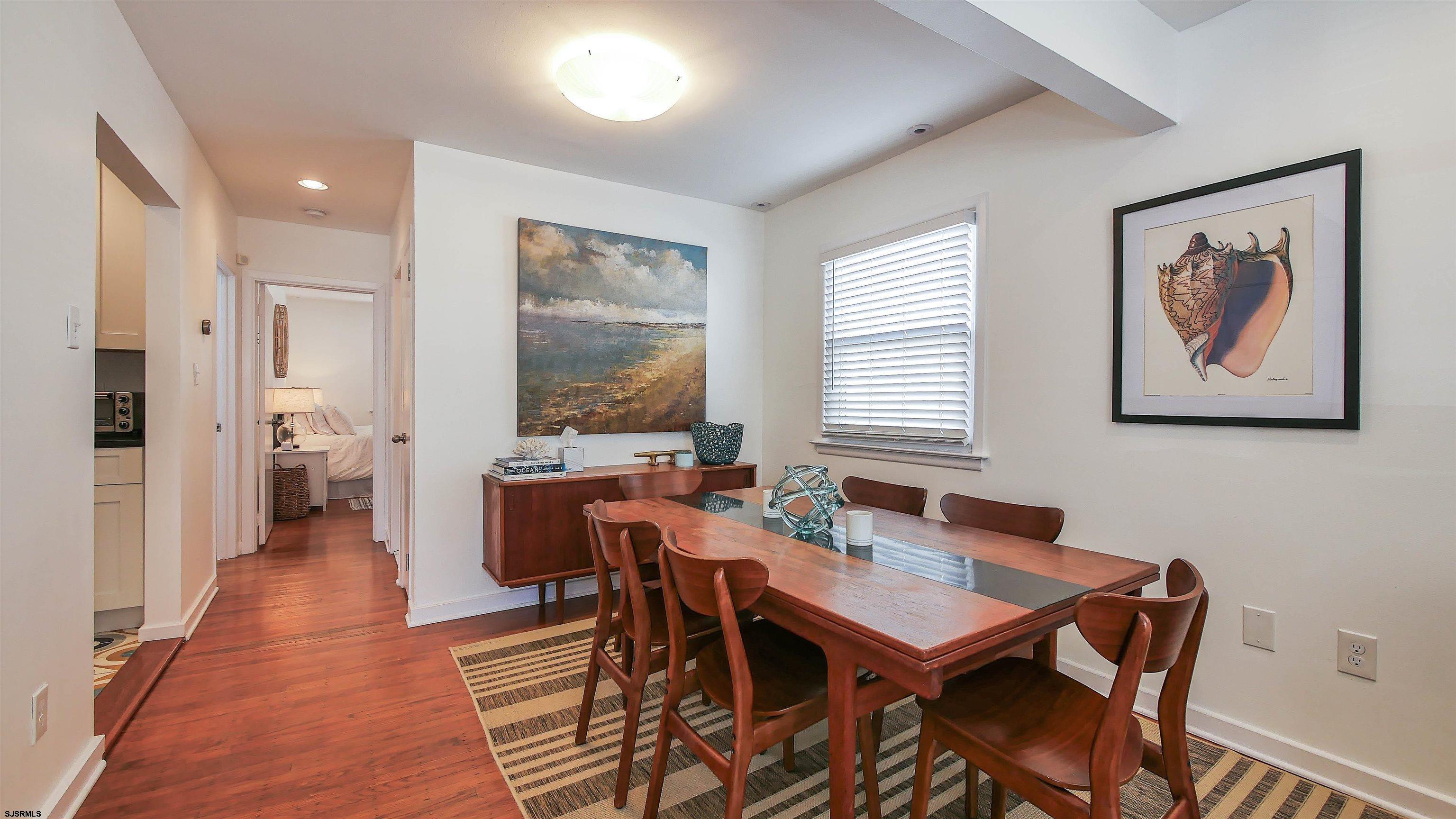 12 North Delavan Avenue, Unit AUGUST 1ST LABOR DAY 2026 Margate City, NJ 08402 - Photo 7 of 41 a view of a dining room with furniture window and wooden floor