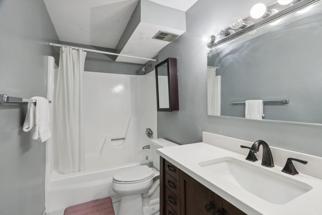 51 Will Drive, Unit 127 Canton, MA 02021 - Photo 11 of 15 a bathroom with a sink toilet and shower