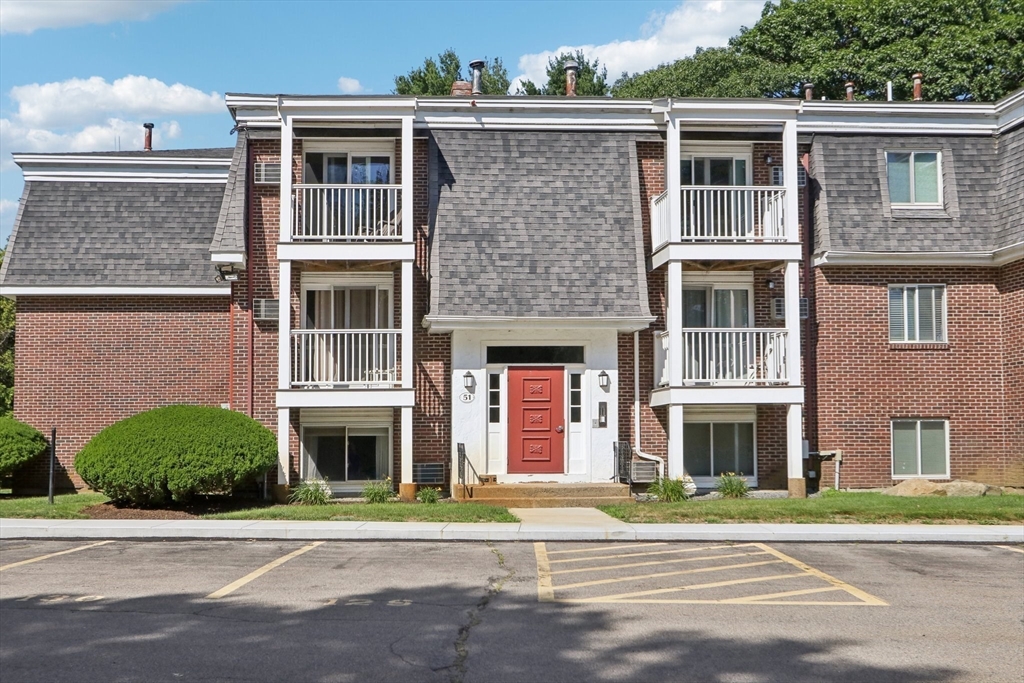 51 Will Drive, Unit 127 Canton, MA 02021 - Photo 2 of 15 a front view of a house with a yard and garage