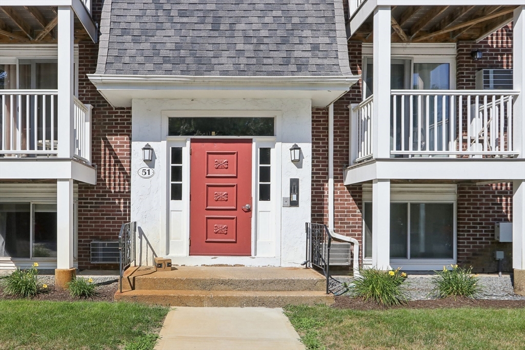 51 Will Drive, Unit 127 Canton, MA 02021 - Photo 3 of 15 a front view of a house with a yard