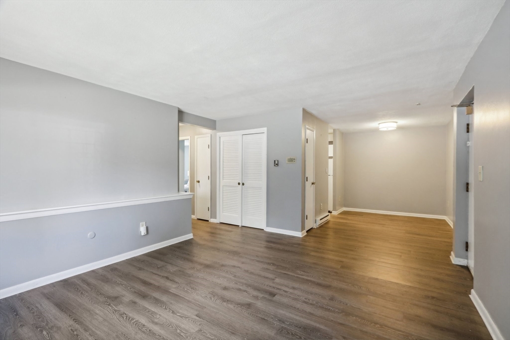 51 Will Drive, Unit 127 Canton, MA 02021 - Photo 6 of 15 a view of an empty room with wooden floor