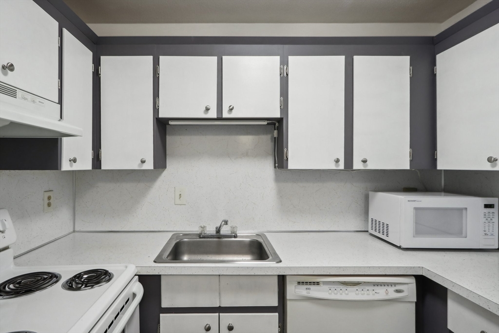 51 Will Drive, Unit 127 Canton, MA 02021 - Photo 8 of 15 a kitchen with a sink and cabinets