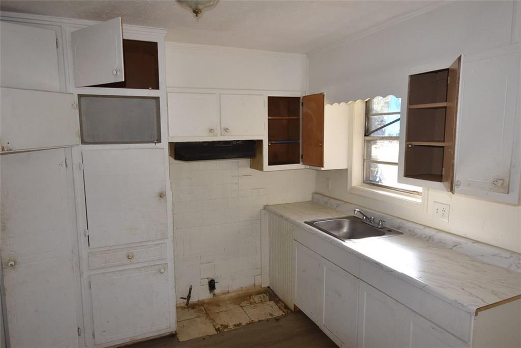 208 Emory Way Oxford, GA 30054 - Photo 8 of 8 a kitchen with a refrigerator and a sink
