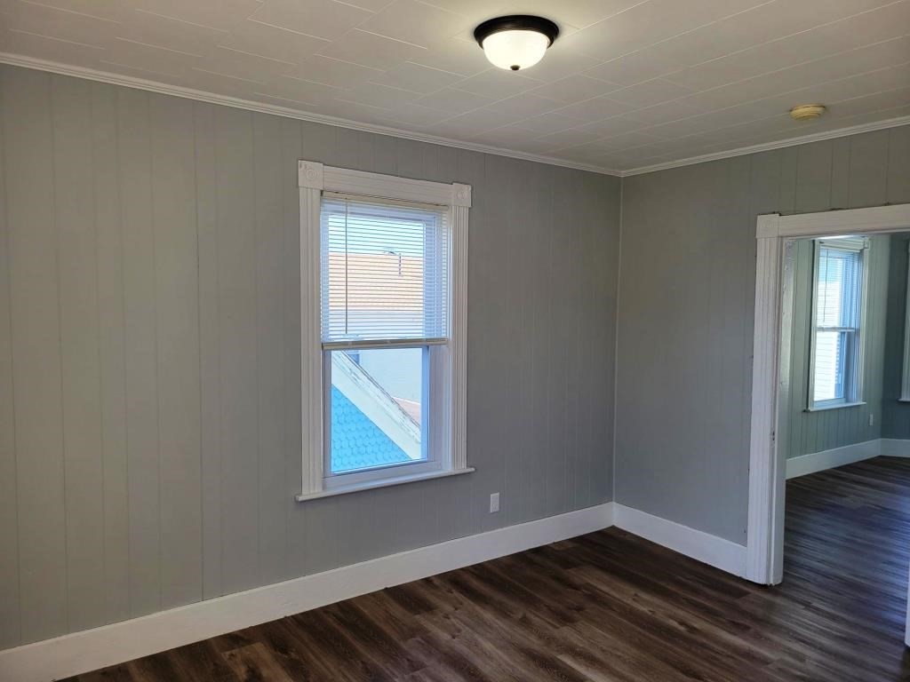 73 1/2 Esther Street, Unit 3 Worcester, MA 01607 - Photo 13 of 22 an empty room with wooden floor and windows