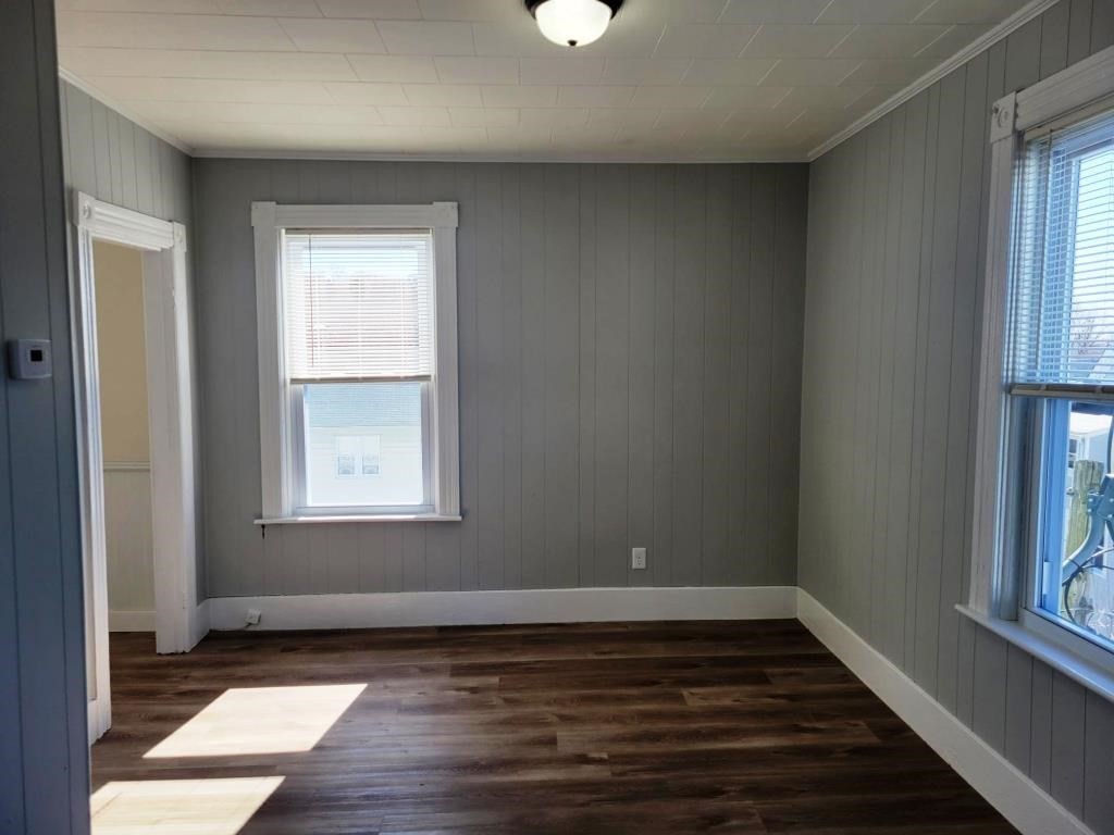 73 1/2 Esther Street, Unit 3 Worcester, MA 01607 - Photo 14 of 22 a view of an empty room with wooden floor and a window
