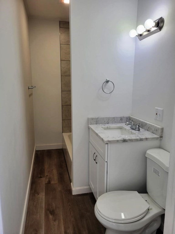 73 1/2 Esther Street, Unit 3 Worcester, MA 01607 - Photo 17 of 22 a bathroom with a granite countertop toilet a sink and mirror