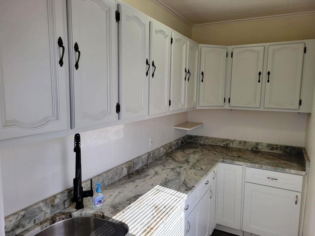73 1/2 Esther Street, Unit 3 Worcester, MA 01607 - Photo 3 of 22 a kitchen with granite countertop white cabinets and white appliances