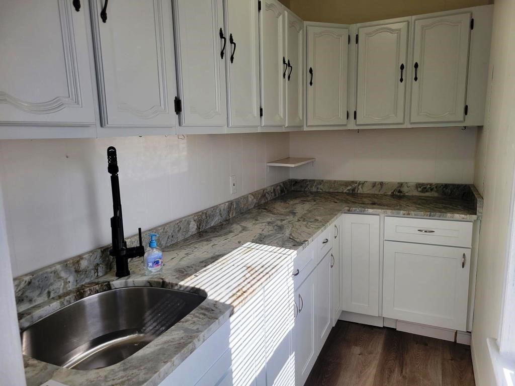 73 1/2 Esther Street, Unit 3 Worcester, MA 01607 - Photo 7 of 22 a kitchen with granite countertop white cabinets and sink