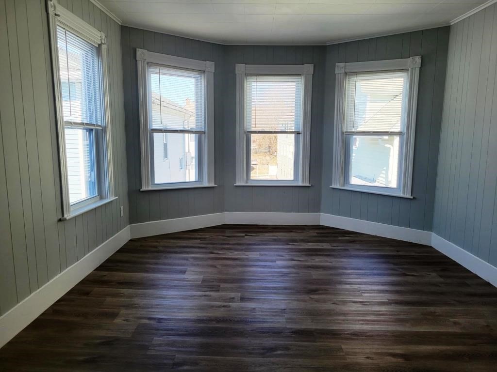 73 1/2 Esther Street, Unit 3 Worcester, MA 01607 - Photo 8 of 22 an empty room with wooden floor and windows