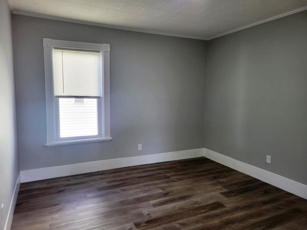 73 1/2 Esther Street, Unit 3 Worcester, MA 01607 - Photo 10 of 22 an empty room with wooden floor and windows