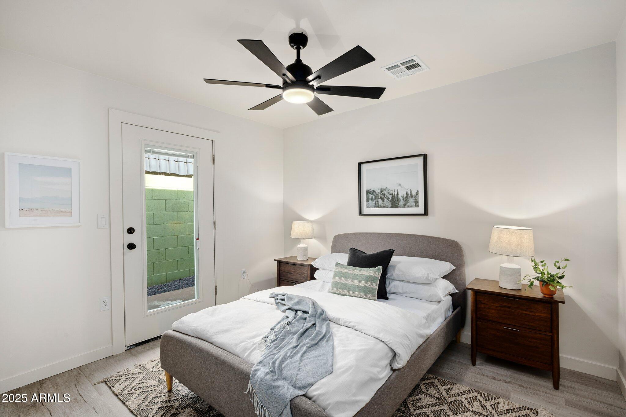 3114 North 68th Street, Unit 2 Scottsdale, AZ 85251 - Photo 7 of 25 a bedroom with a bed and a chandelier