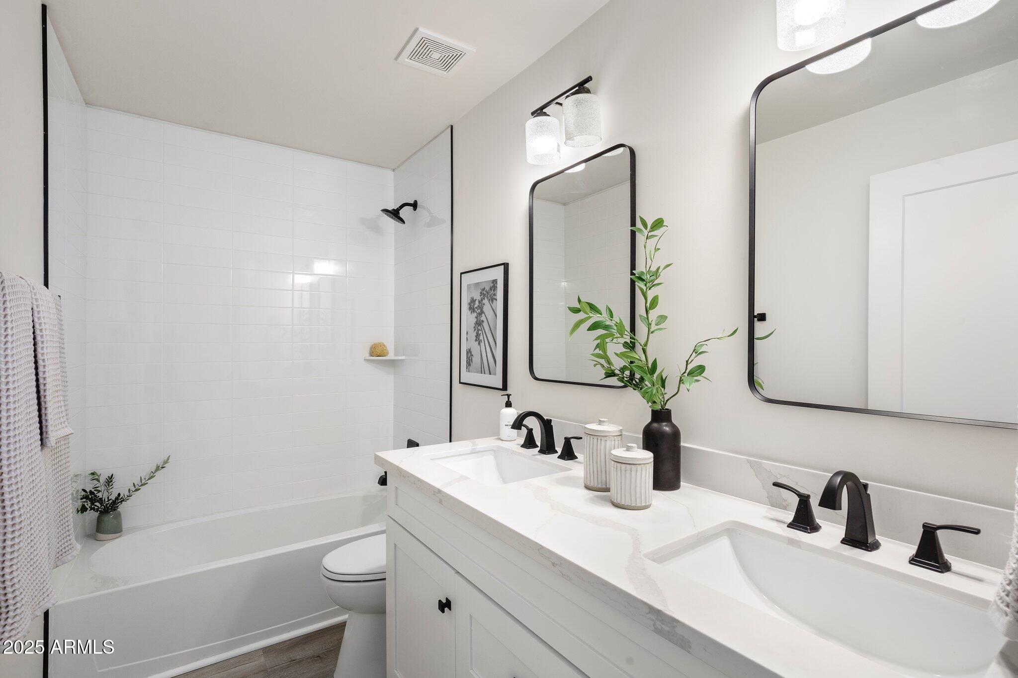 3114 North 68th Street, Unit 2 Scottsdale, AZ 85251 - Photo 9 of 25 a bathroom with a sink a toilet and a mirror