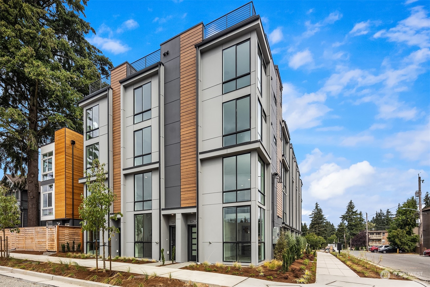 3112 Northeast 120th Street Seattle, WA 98125 - Photo 26 of 26 a front view of a residential apartment building with a yard