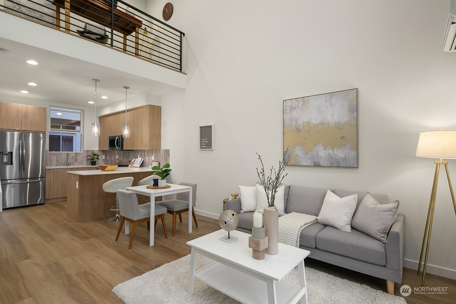 3112 Northeast 120th Street Seattle, WA 98125 - Photo 6 of 26 a living room with a couch and a dining table with wooden floor