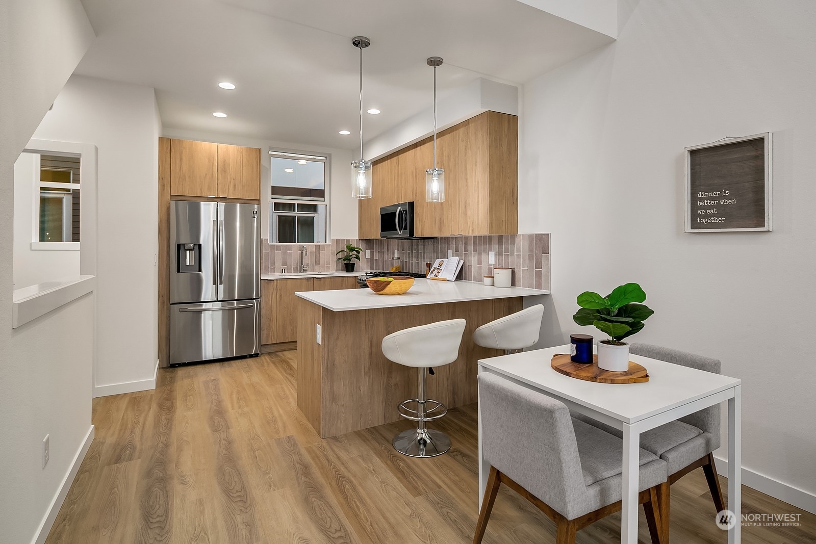 3112 Northeast 120th Street Seattle, WA 98125 - Photo 9 of 26 a kitchen with a sink stainless steel appliances and white cabinets