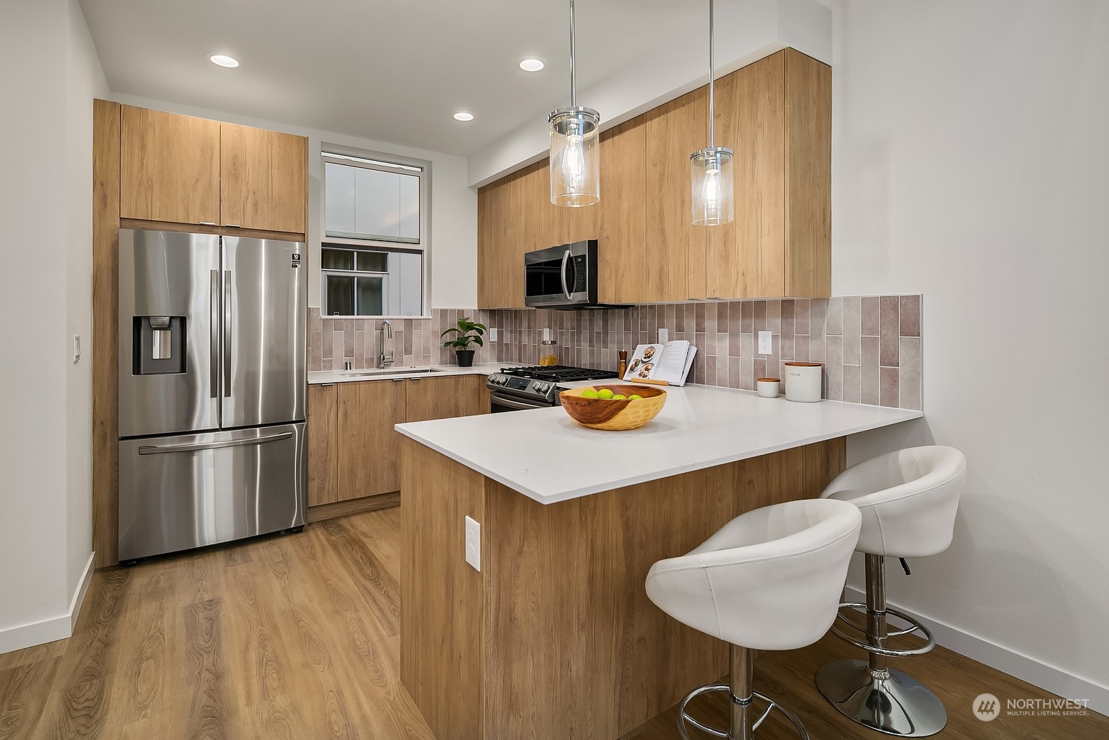 3112 Northeast 120th Street Seattle, WA 98125 - Photo 10 of 26 a kitchen with a sink a refrigerator and chairs