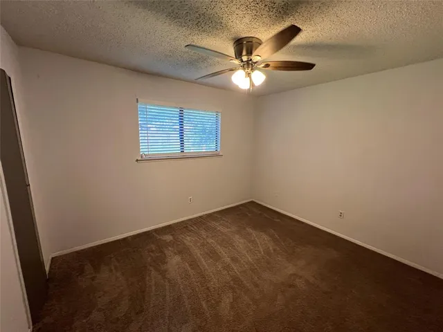 a spacious bathroom with a sink a toilet and a bathtub