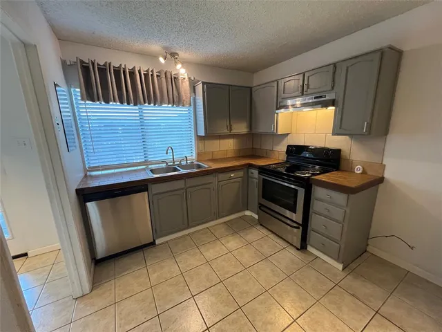 a kitchen with a stove and a refrigerator