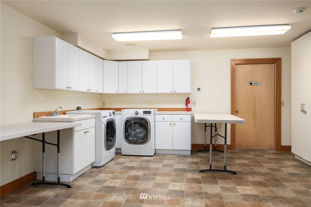 4129 Point Williams Place Bow, WA 98232 - Photo 36 of 40 a utility room with cabinets washer and dryer