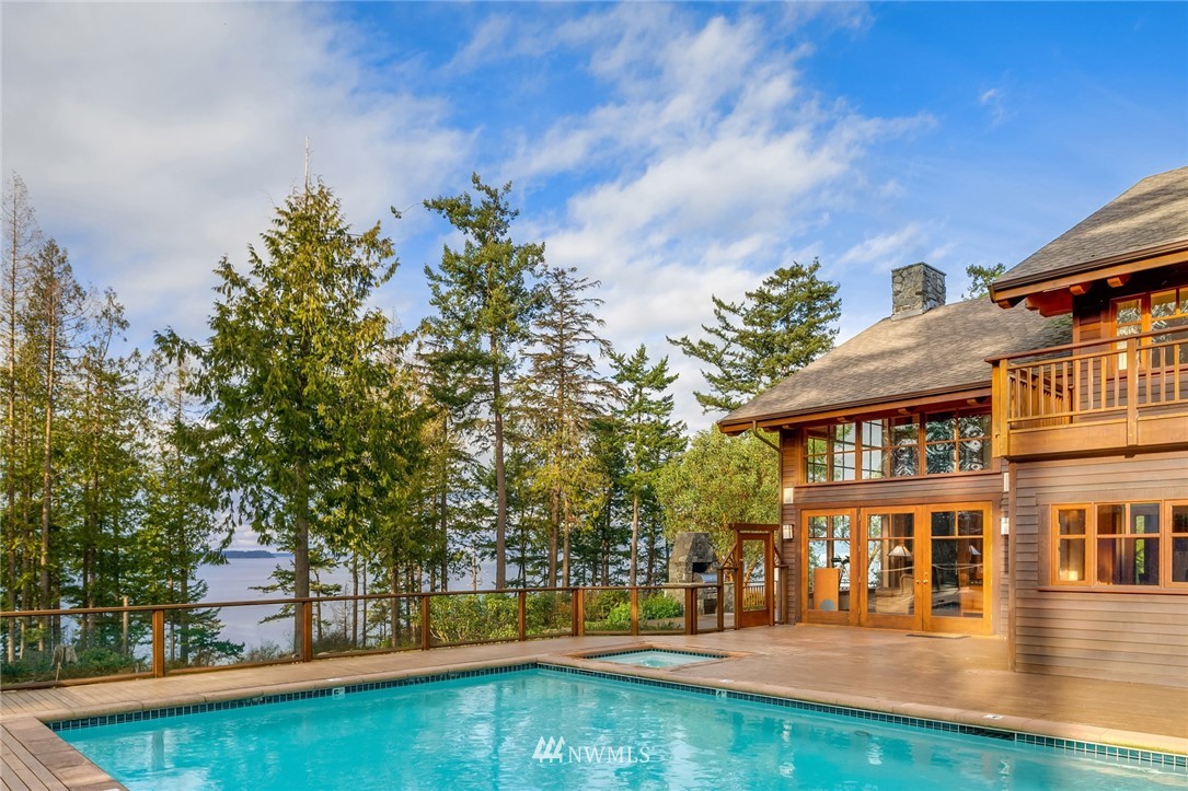 4129 Point Williams Place Bow, WA 98232 - Photo 7 of 40 a view of swimming pool with outdoor seating and trees in the background