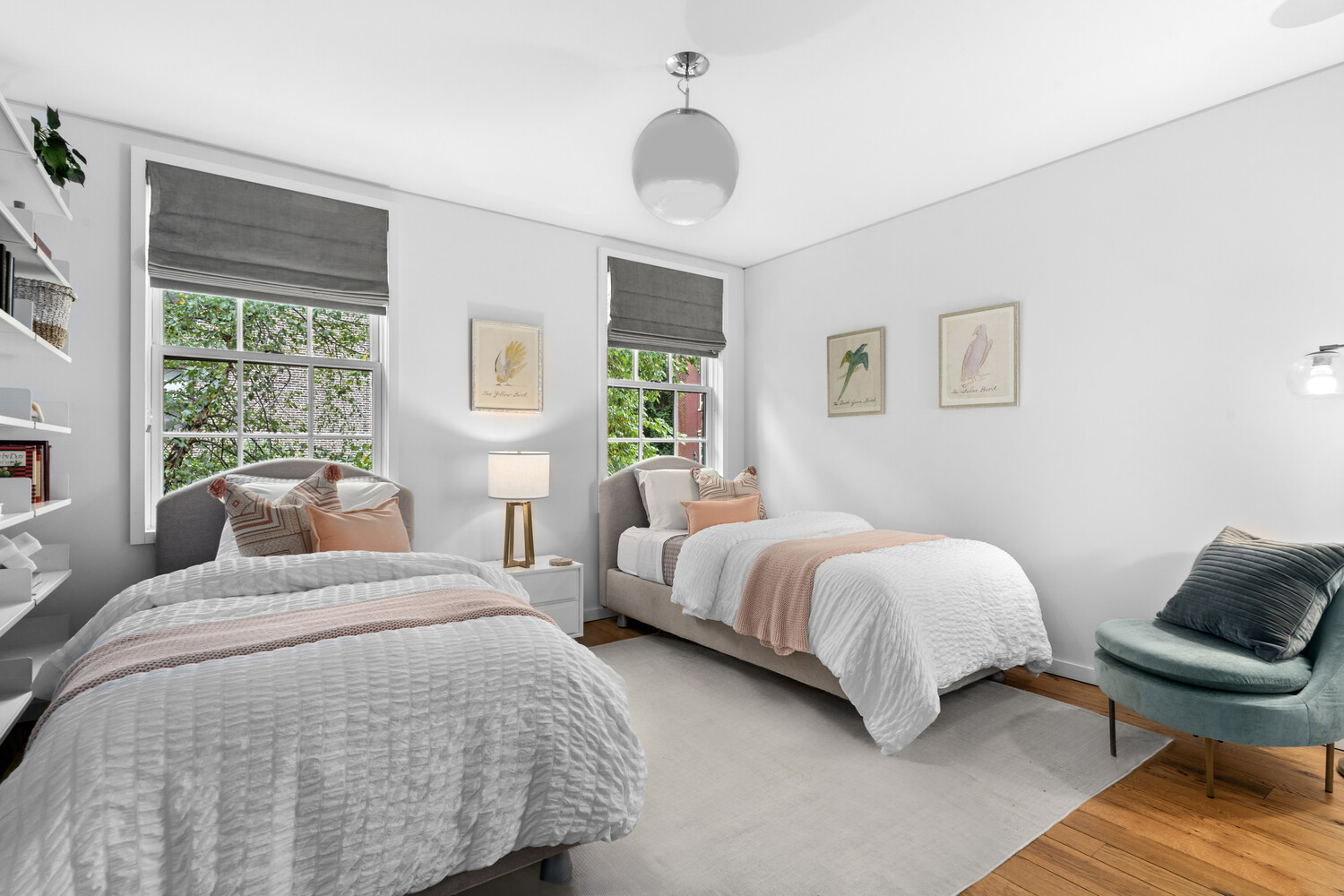 430 Hudson Street Manhattan, NY 10014 - Photo 12 of 35 a bedroom with two beds and a chandelier