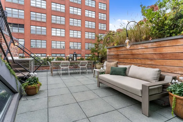 a view of roof deck with patio
