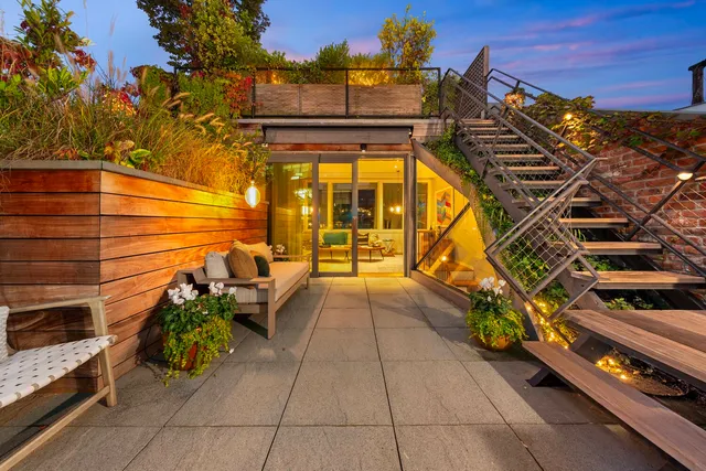 a view of a patio with couches and potted plants