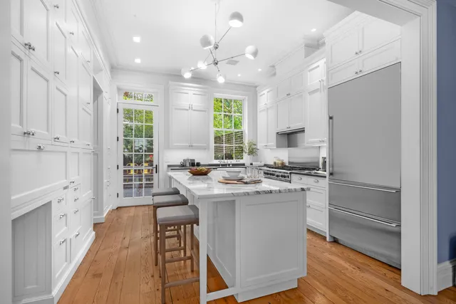 a view of a dining room with furniture wooden floor and chandelier