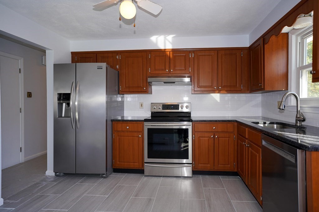 3 Rickey Drive Maynard, MA 01754 - Photo 2 of 25 a kitchen with stainless steel appliances granite countertop a stove a sink and a refrigerator