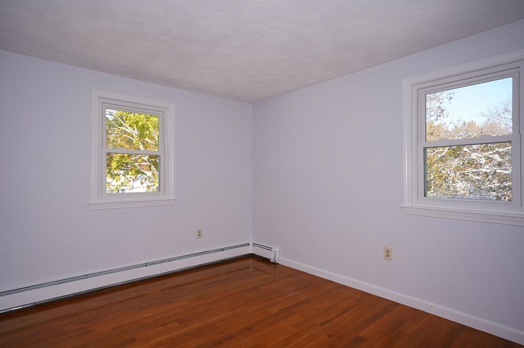 3 Rickey Drive Maynard, MA 01754 - Photo 9 of 25 a view of an empty room with wooden floor and a window