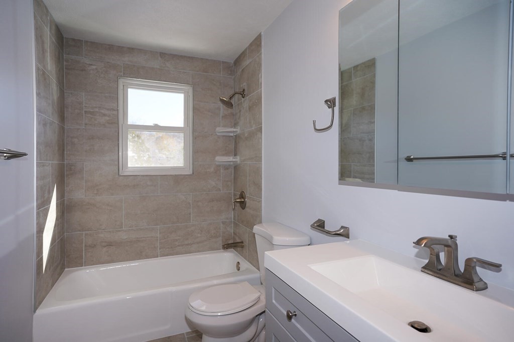 3 Rickey Drive Maynard, MA 01754 - Photo 10 of 25 a bathroom with a bathtub shower sink vanity and toilet