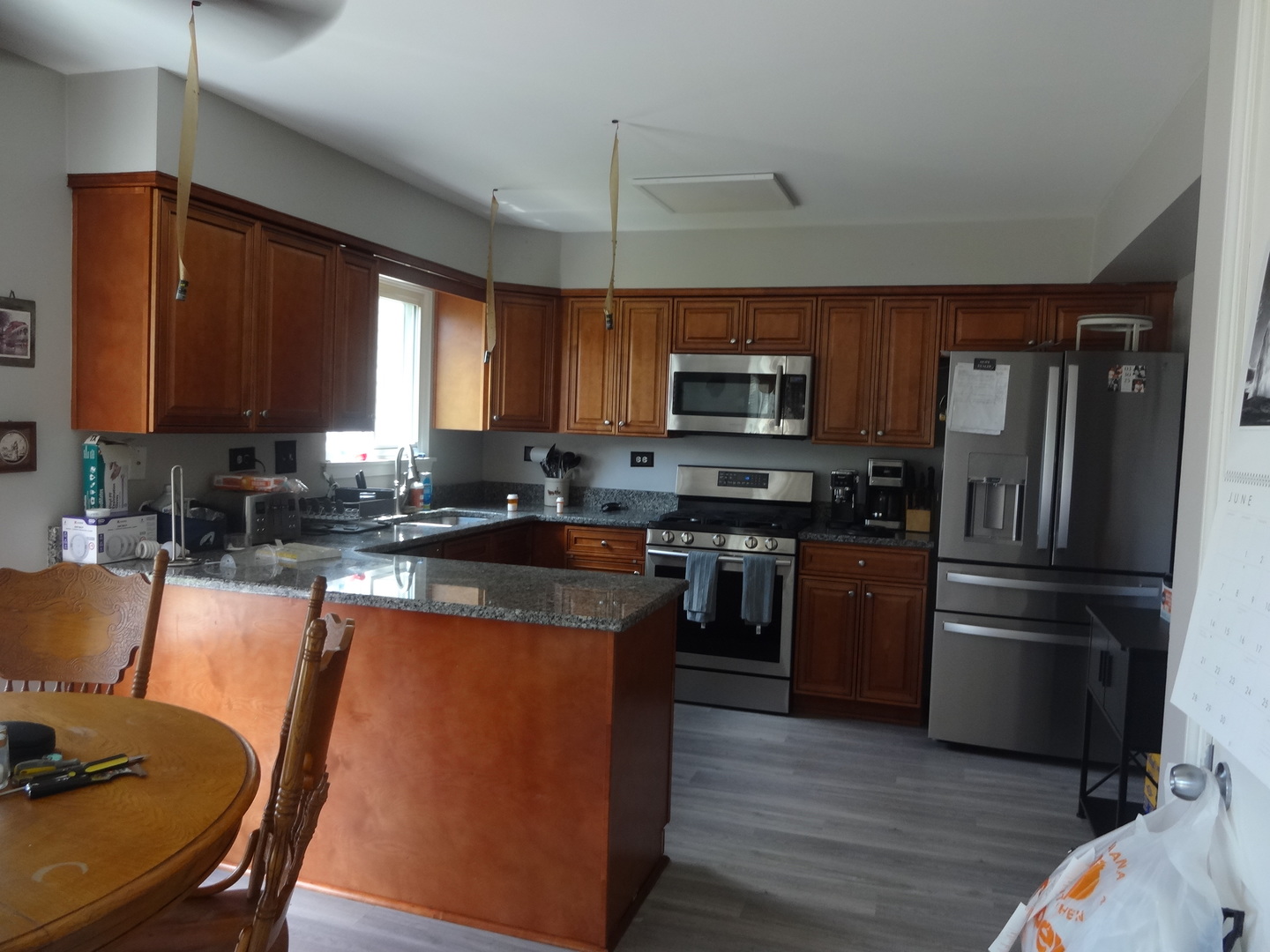 1230 Trinity Drive Carol Stream, IL 60188 - Photo 1 of 1 a kitchen with granite countertop wooden cabinets a stove top oven a sink and dishwasher