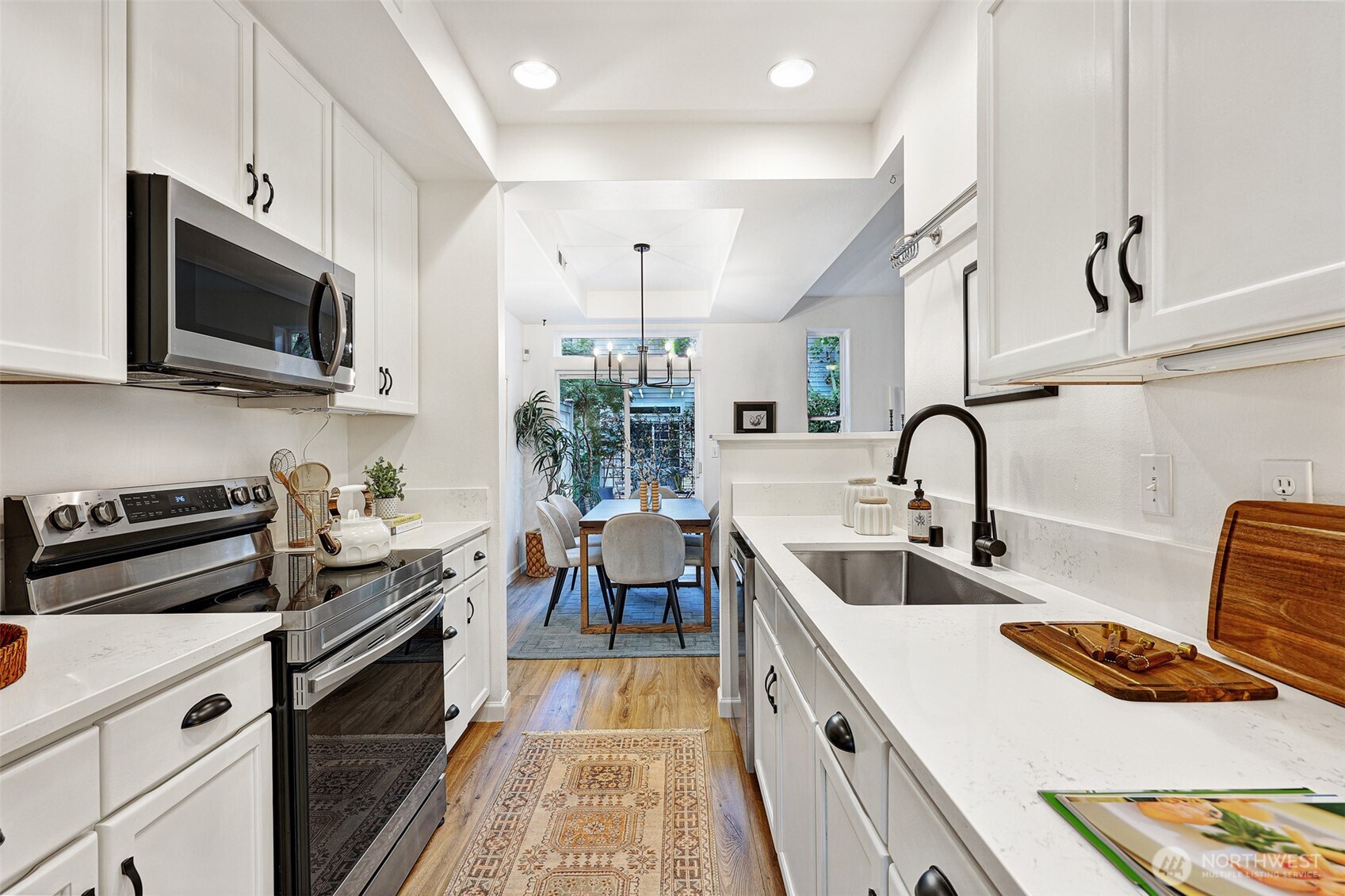 8828 238th Street Southwest, Unit B4 Edmonds, WA 98026 - Photo 12 of 37 a kitchen with stainless steel appliances granite countertop a sink and a stove